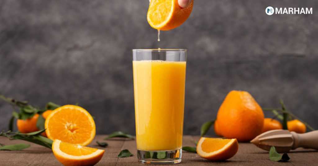 Some cut orange piece and glass of juice